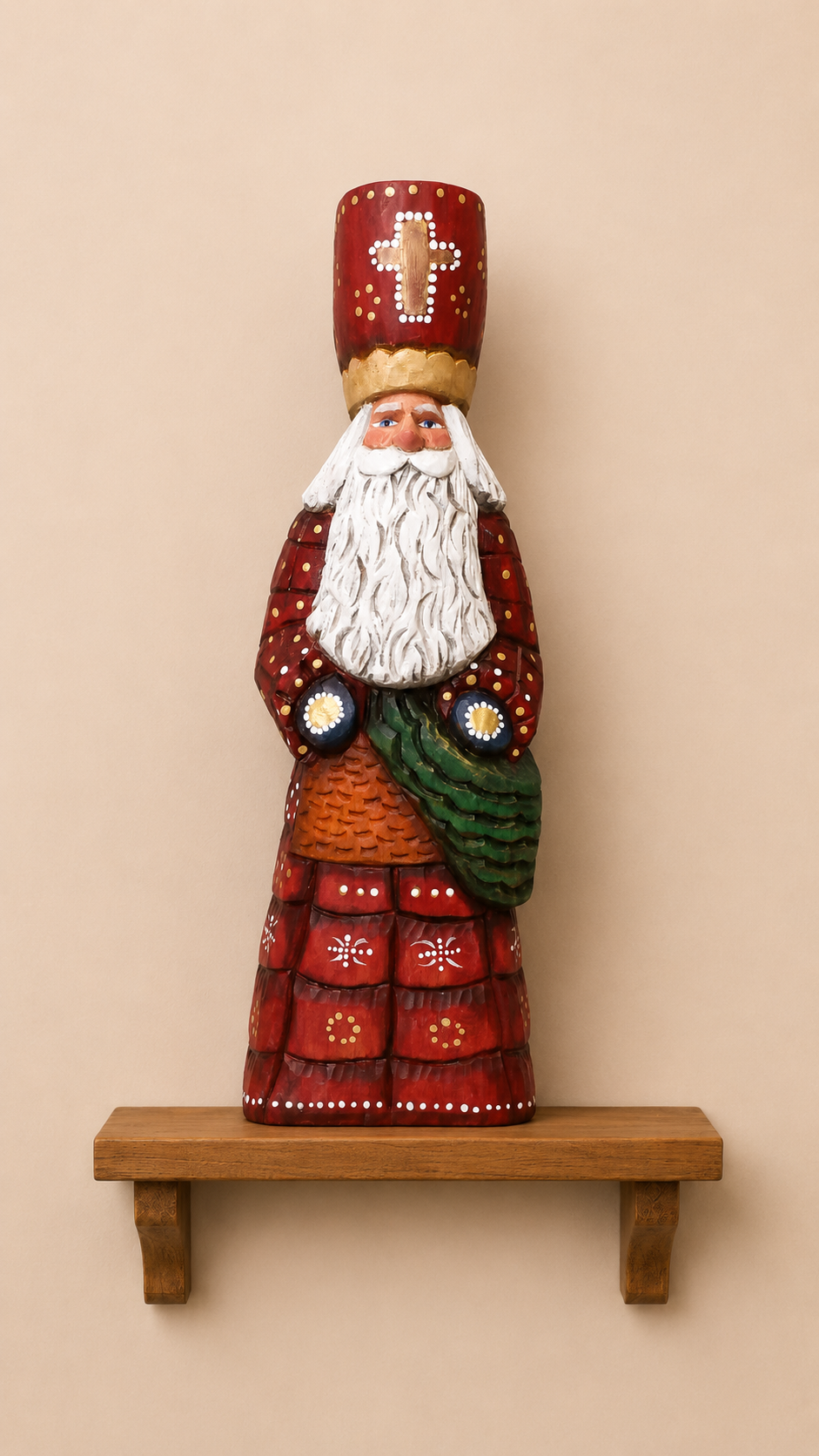 Saint Nicholas wood carving in red bishop's robes with gold mitre and white beard, displayed on a wooden shelf