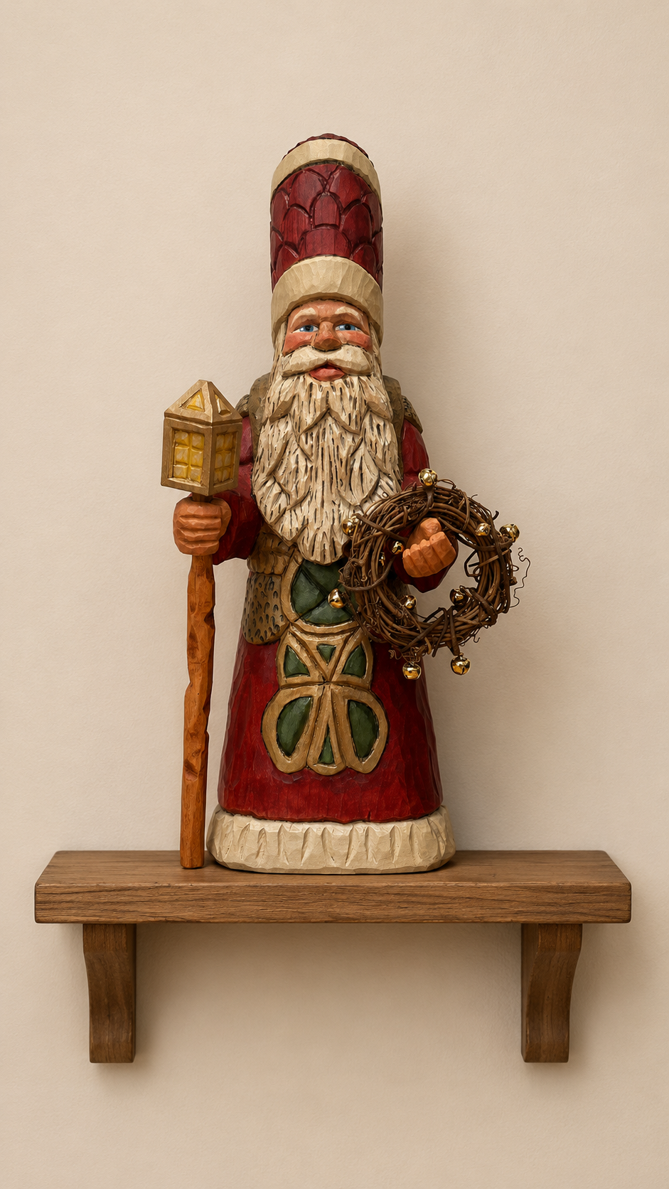 Father Christmas wood carving in red robe with lantern staff and jingle bell wreath, displayed on a wooden shelf