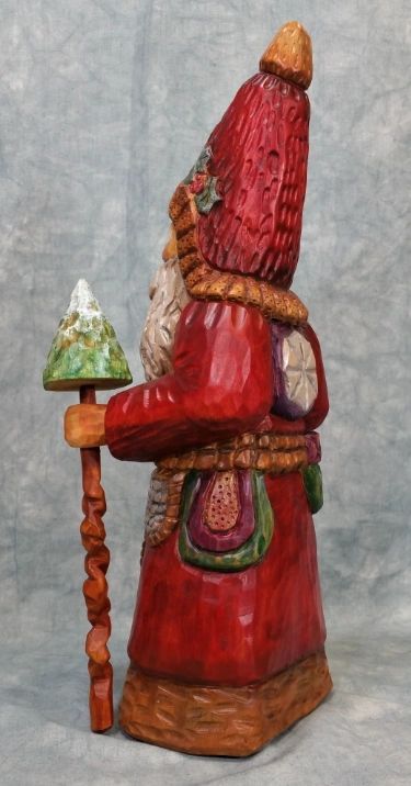 Father Christmas wood carving in traditional robes, front view