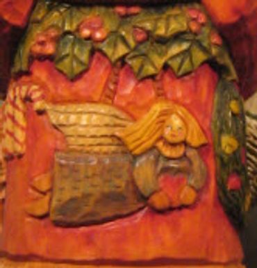 Father Christmas wood carving with detailed robe and staff