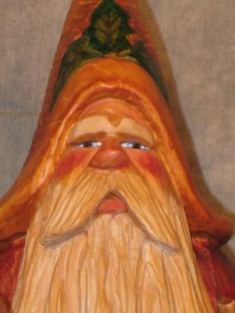 Painted portrait of Father Christmas figure in red robe with long beard