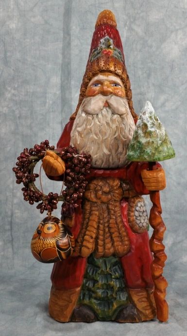 Father Christmas wood carving in warm orange robes