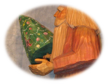 Group display of Father Christmas carved faces and figures