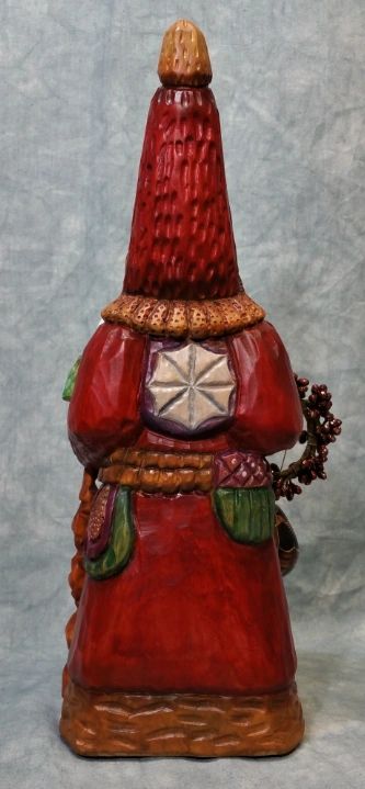 Father Christmas wood carving in deep red robe