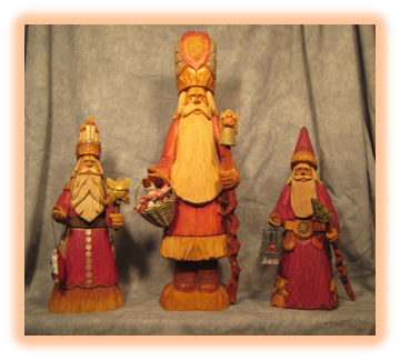 Group of Father Christmas wood carvings displayed together